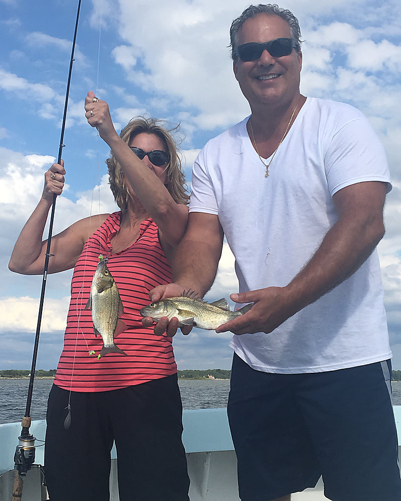A couple on the boat with their fish